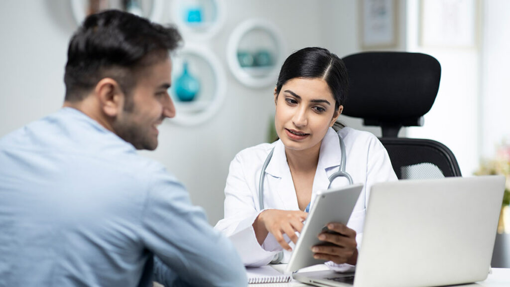 A doctor introduces a patient to ePRO during a trial visit